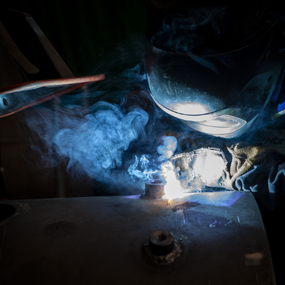 Close up of a man welding a joint on a blowdown vessel. The welding is creating fumes which are being sucked up by an extractor intenance, Breakdowns & Callouts, Upgrade & Repairs, and Energy Consultancy. This means we can guarantee to have the right en